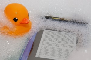 Kindle 3 floating in Trendy Digital case, with rubber duck looking on